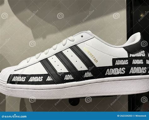 all white adidas with black stripes